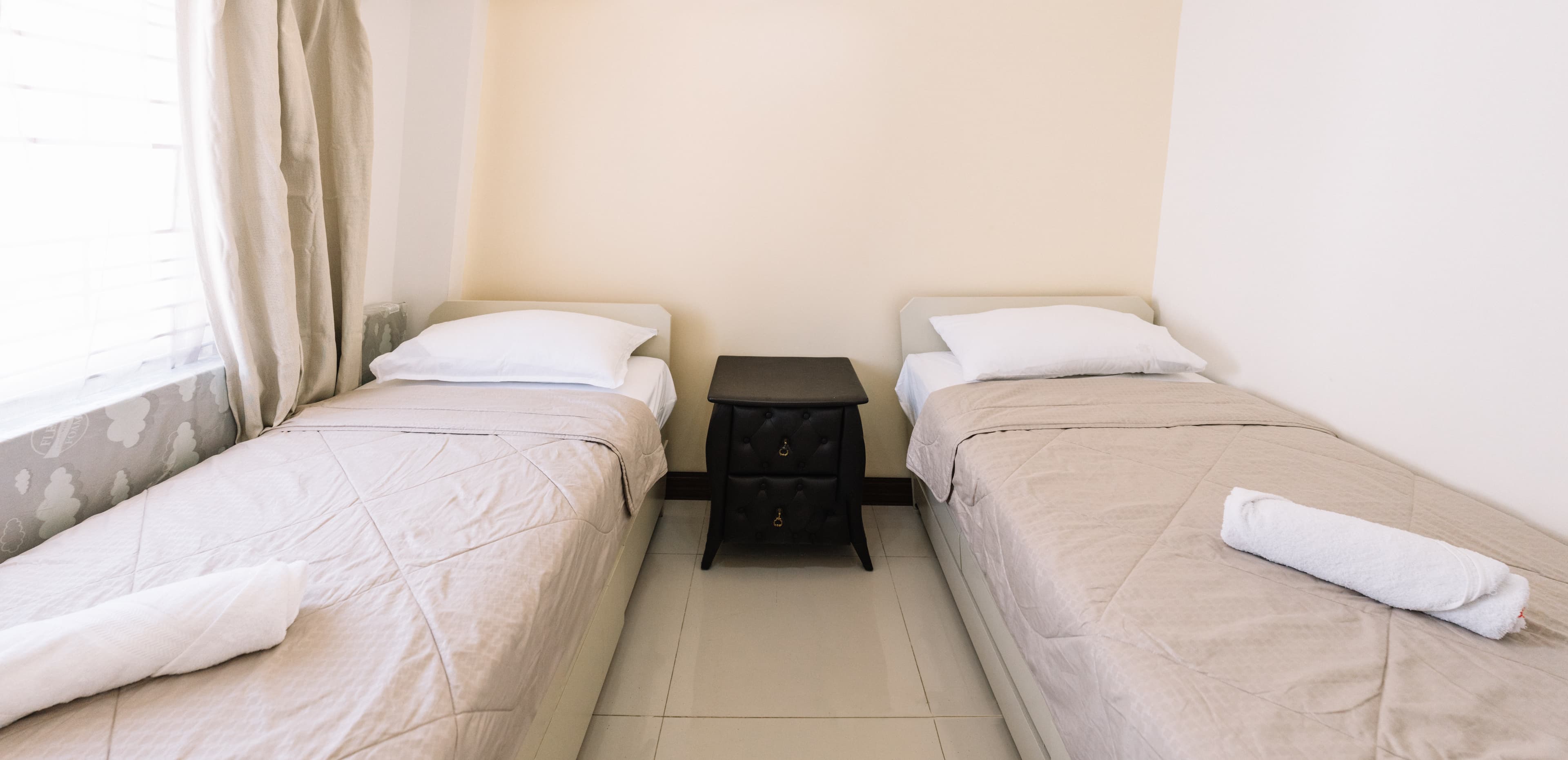 Bedroom with single beds in Baguio apartment